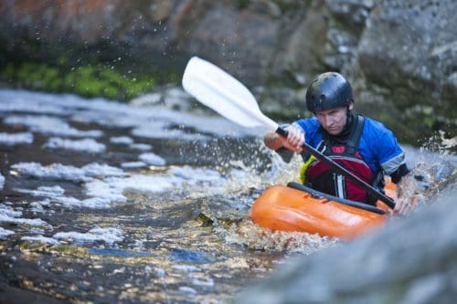 Mountain View Cabin Rentals kayaking on river rapids